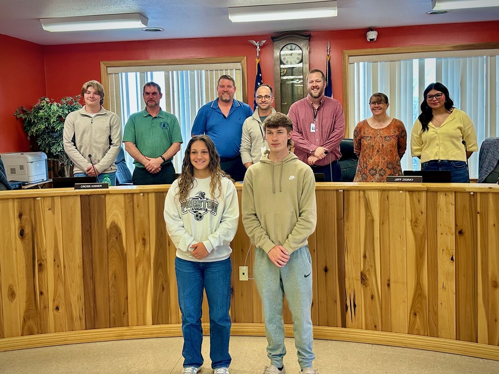 students pose with board members to be recognized for achievement