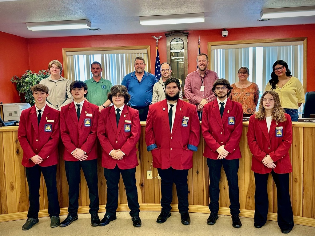students pose with board members to be recognized for achievement