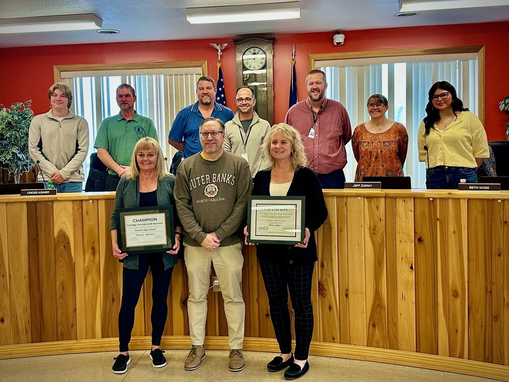 students pose with board members to be recognized for achievement