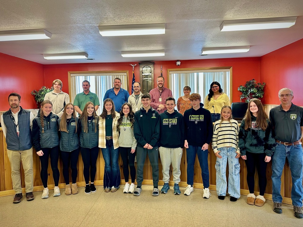 students pose with board members to be recognized for achievement