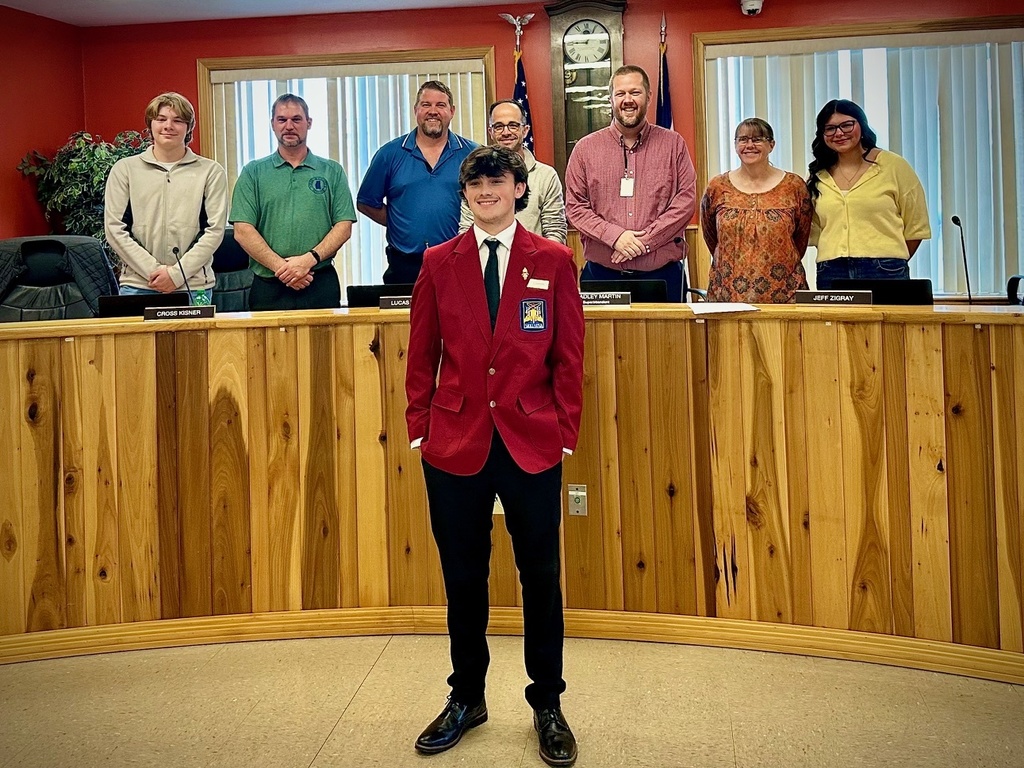 students pose with board members to be recognized for achievement