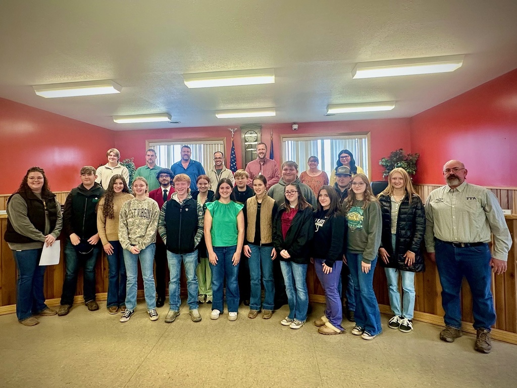 students pose with board members to be recognized for achievement