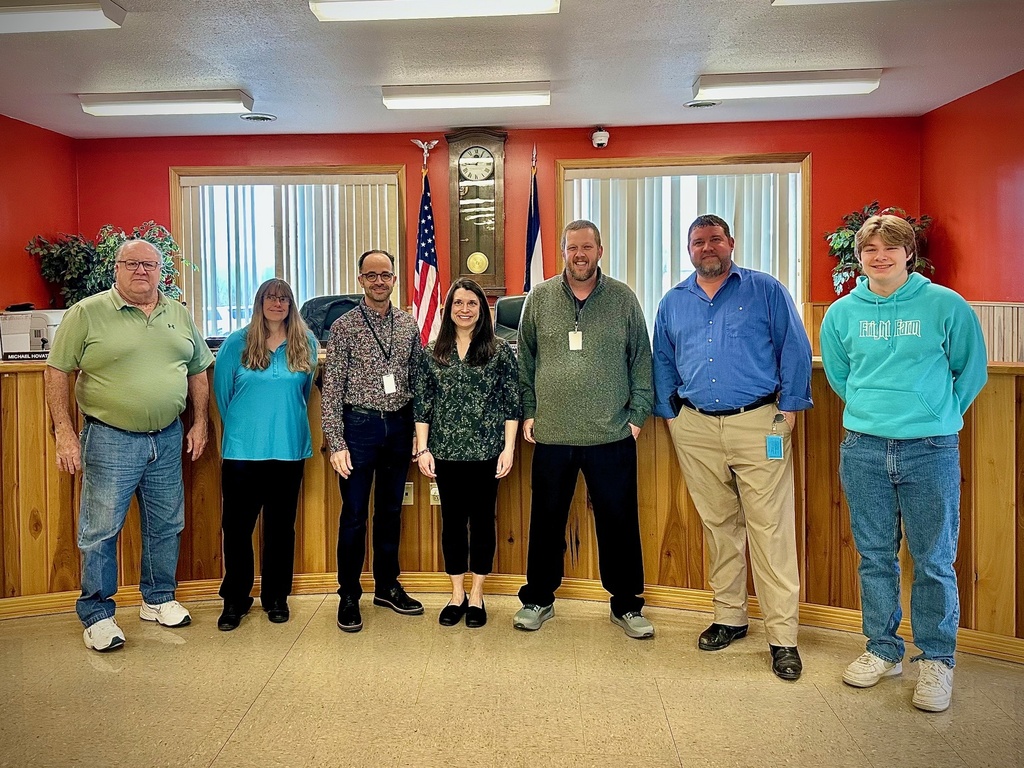 female school principal poses with board members to be recognized