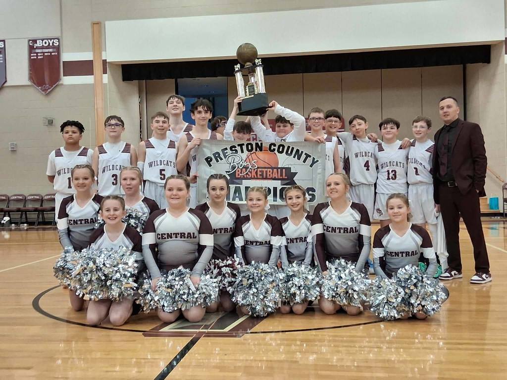 basketball team poses with championship trophy