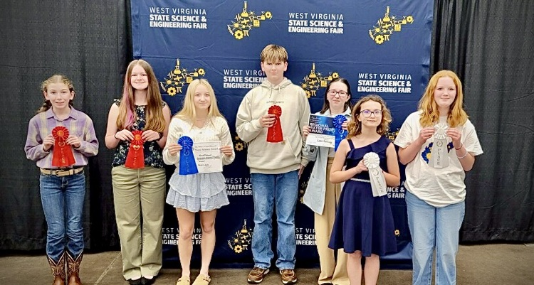 students pose with science fair awards 