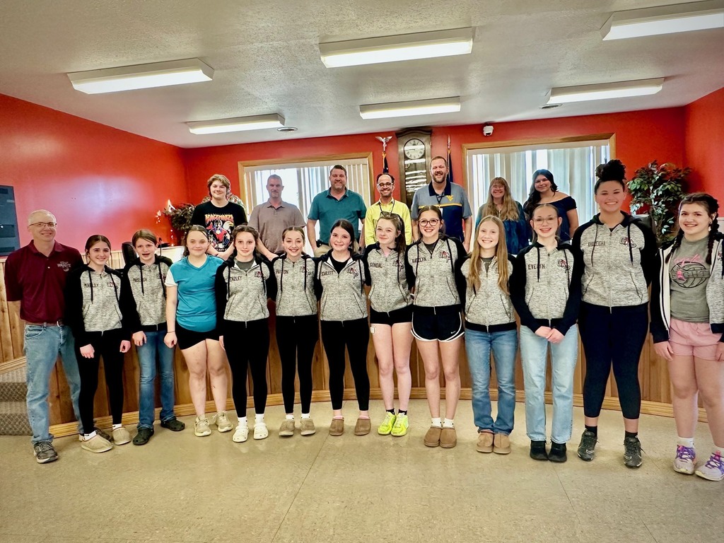 students pose with board members to be recognized for achievement