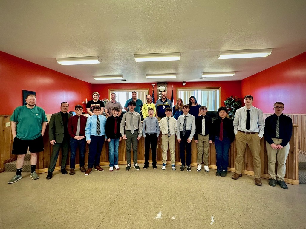 students pose with board members to be recognized for achievement