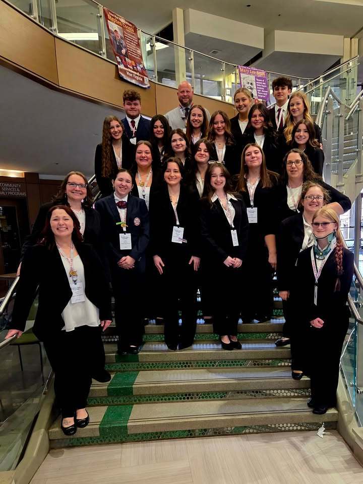students pose with advisors at an awards ceremony