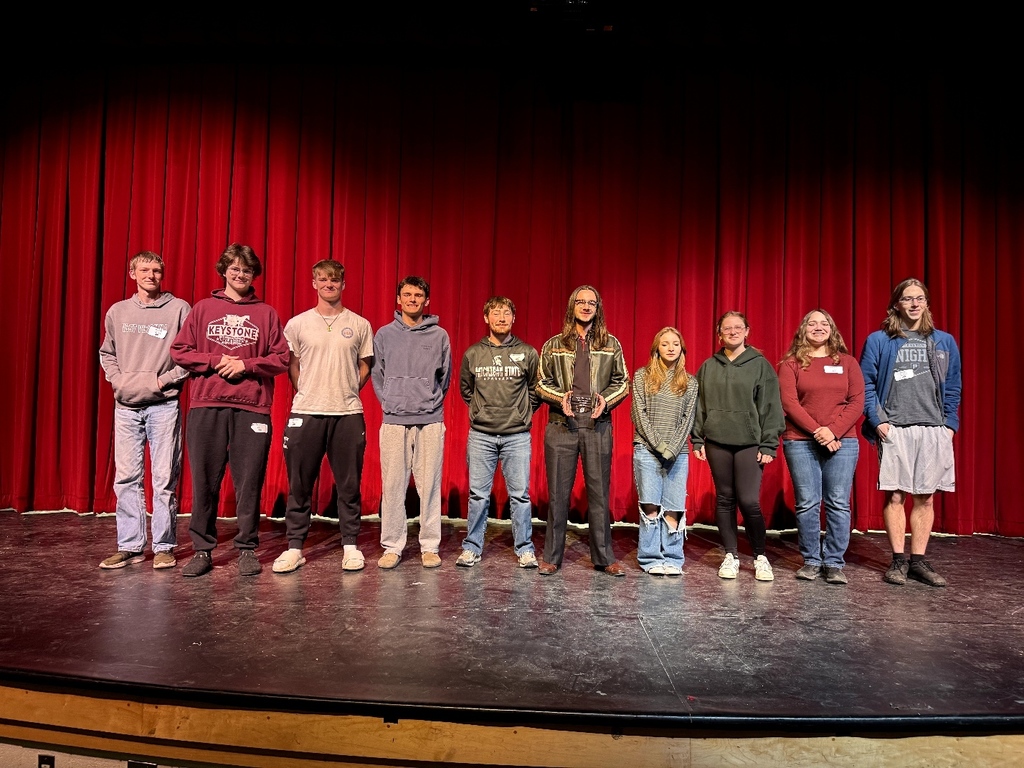 student poses with award