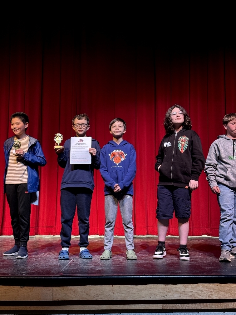 student poses with award