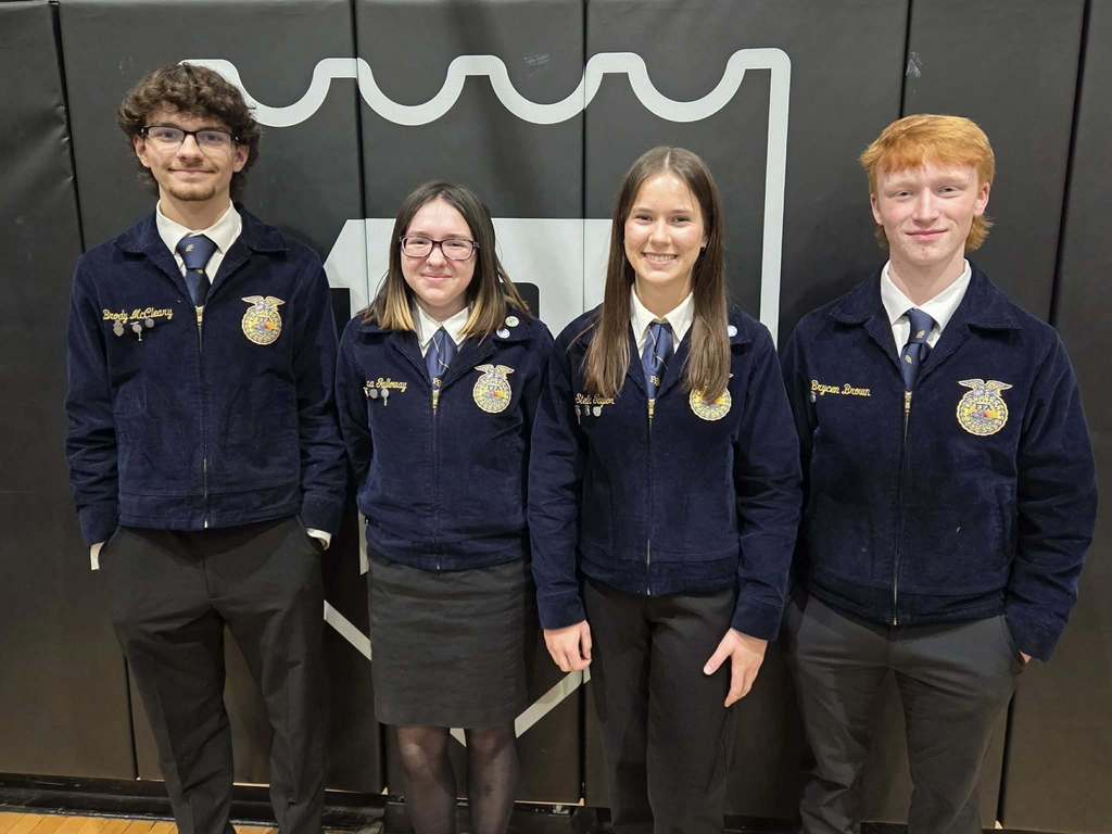 student poses with award