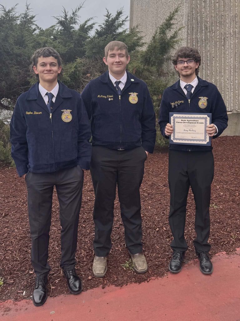 student poses with award