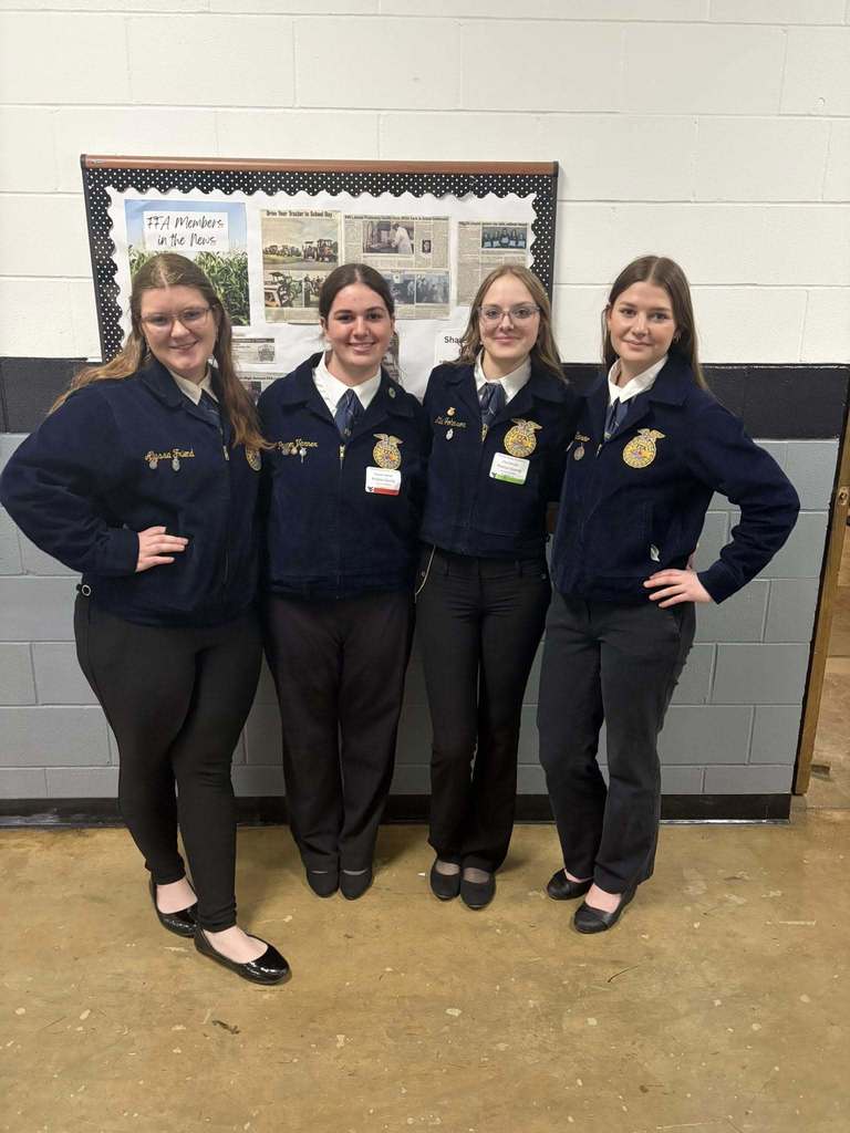 student poses with award