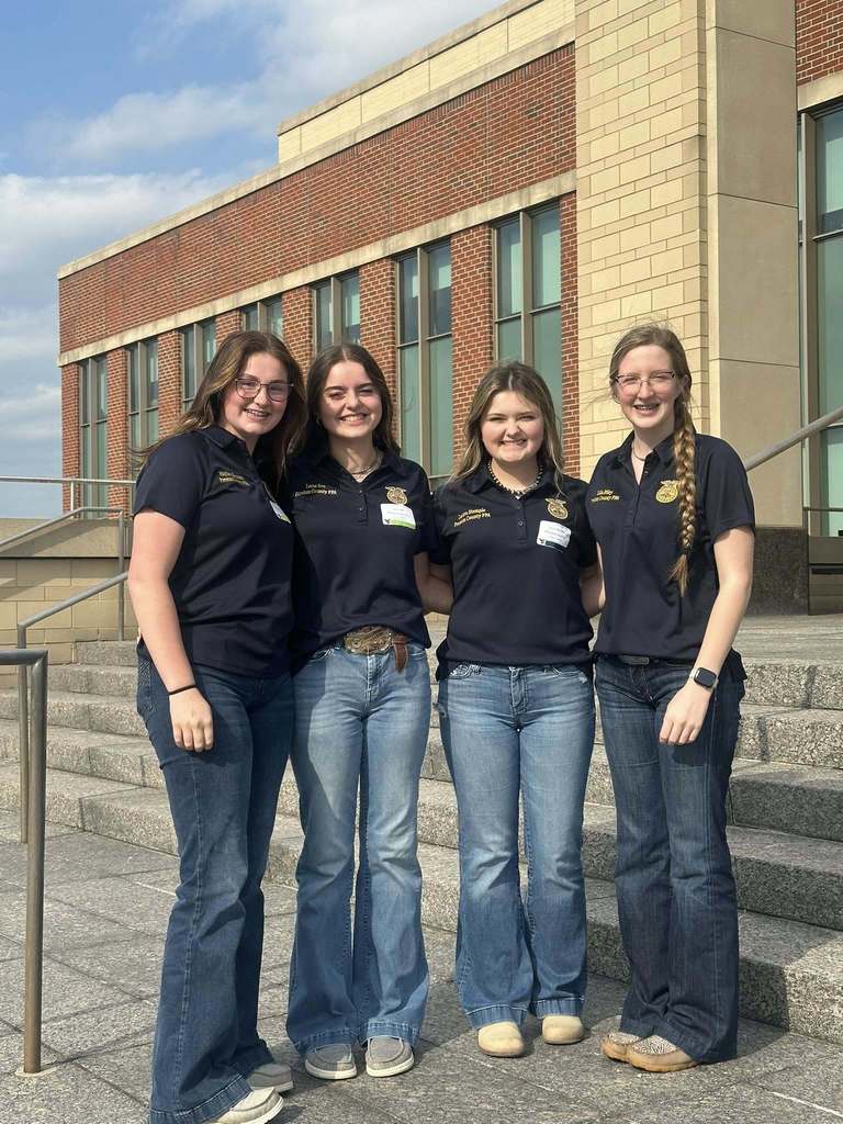student poses with award