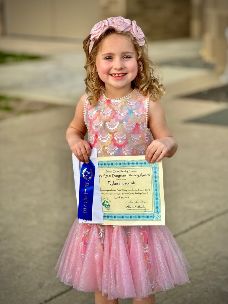 student poses with award