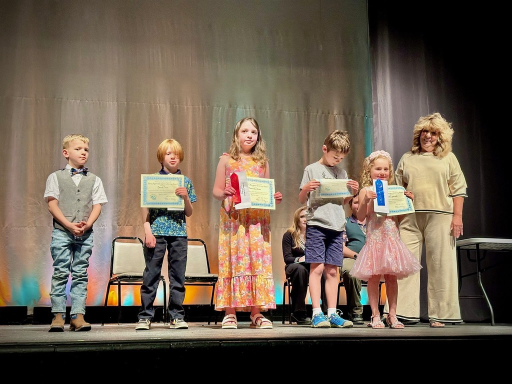 student poses with award