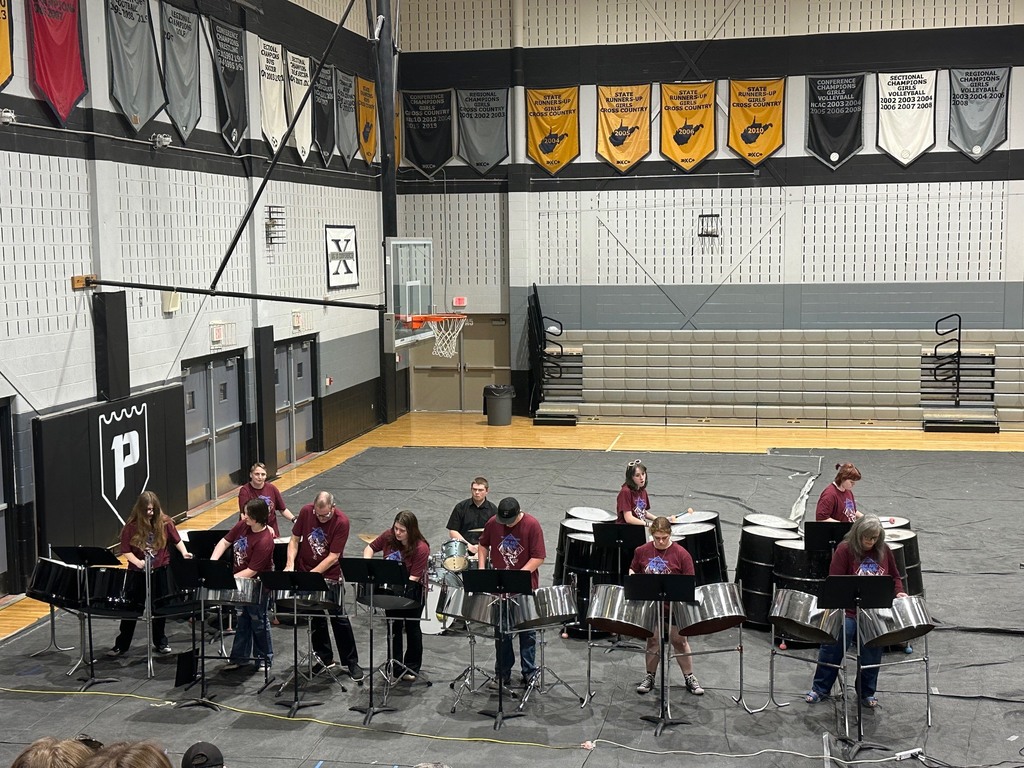 a high school steel drum band performs in a gym