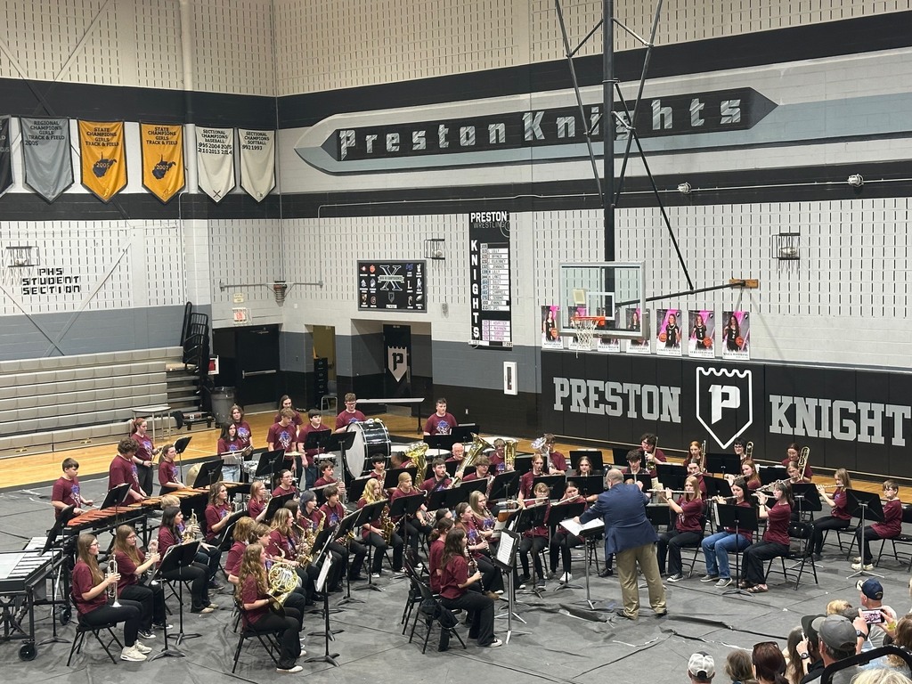 a high school band performs in a gym