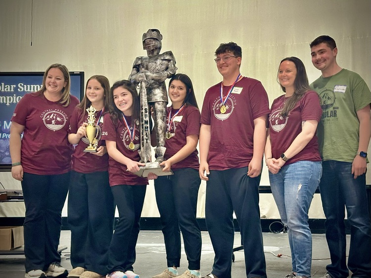 students pose with trophy 