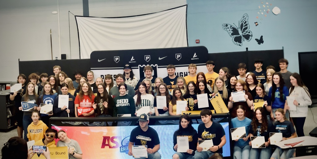 students pose for college signing day
