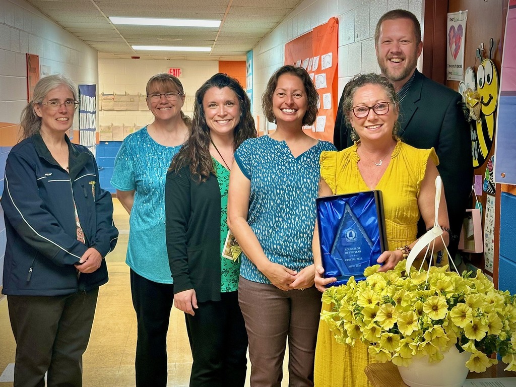 students pose with board members to be recognized for achievement