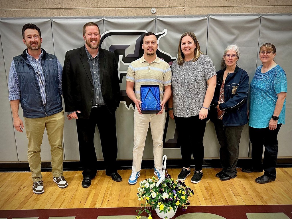 students pose with board members to be recognized for achievement