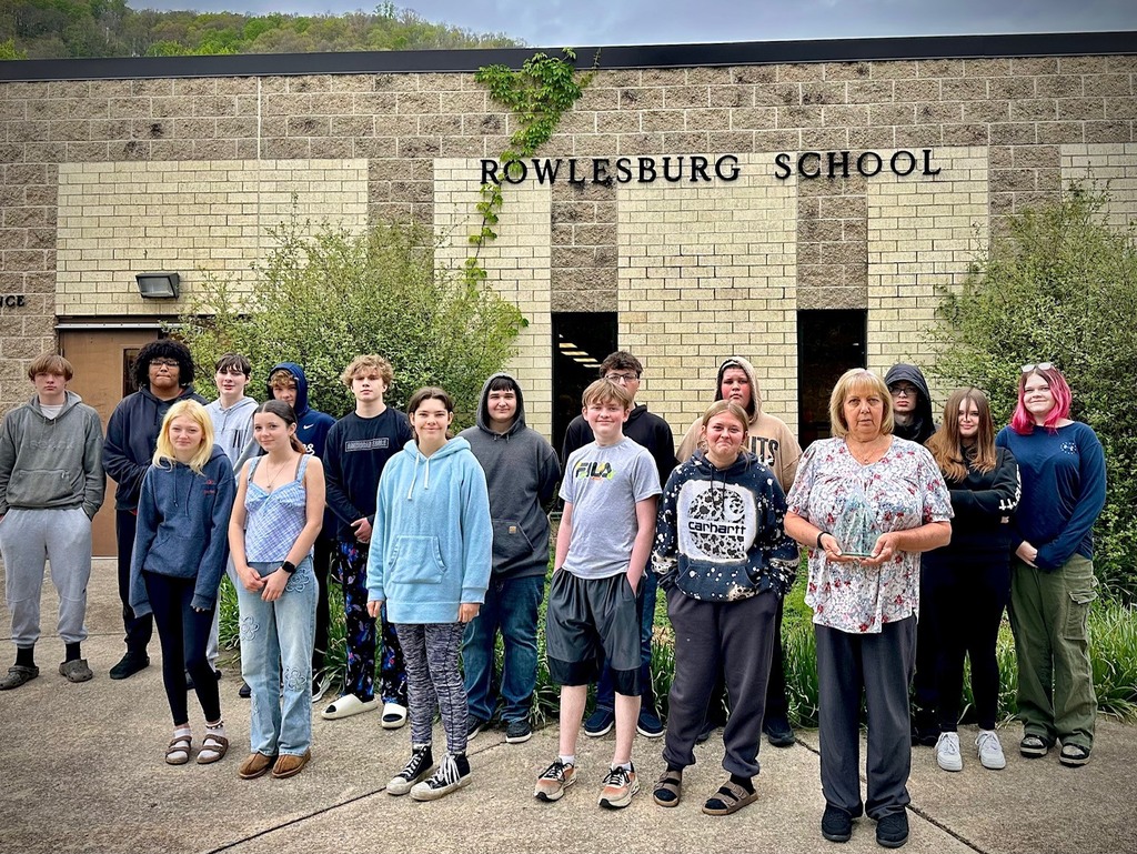 students pose with board members to be recognized for achievement