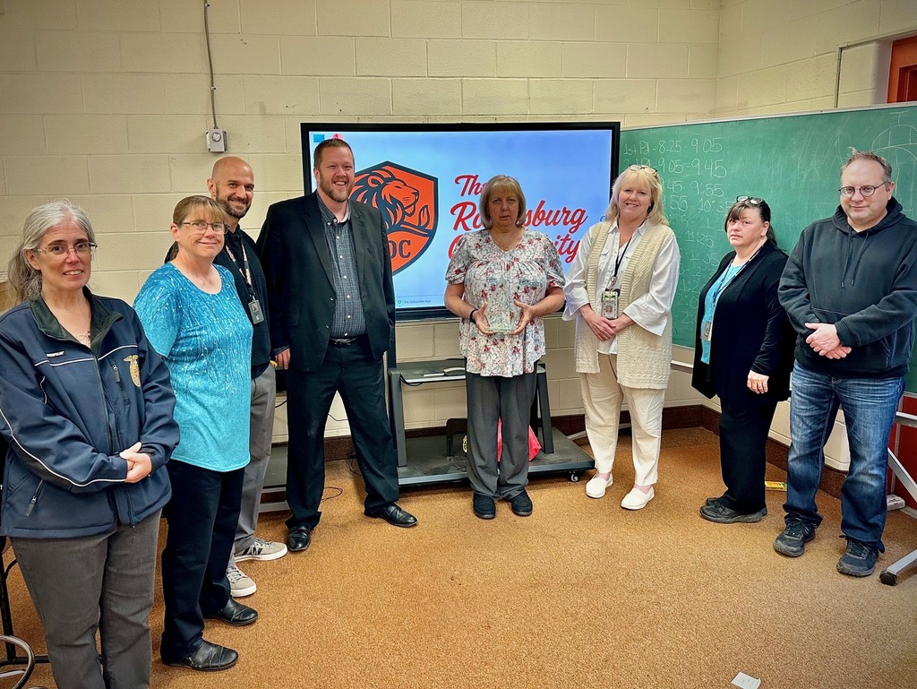 students pose with board members to be recognized for achievement