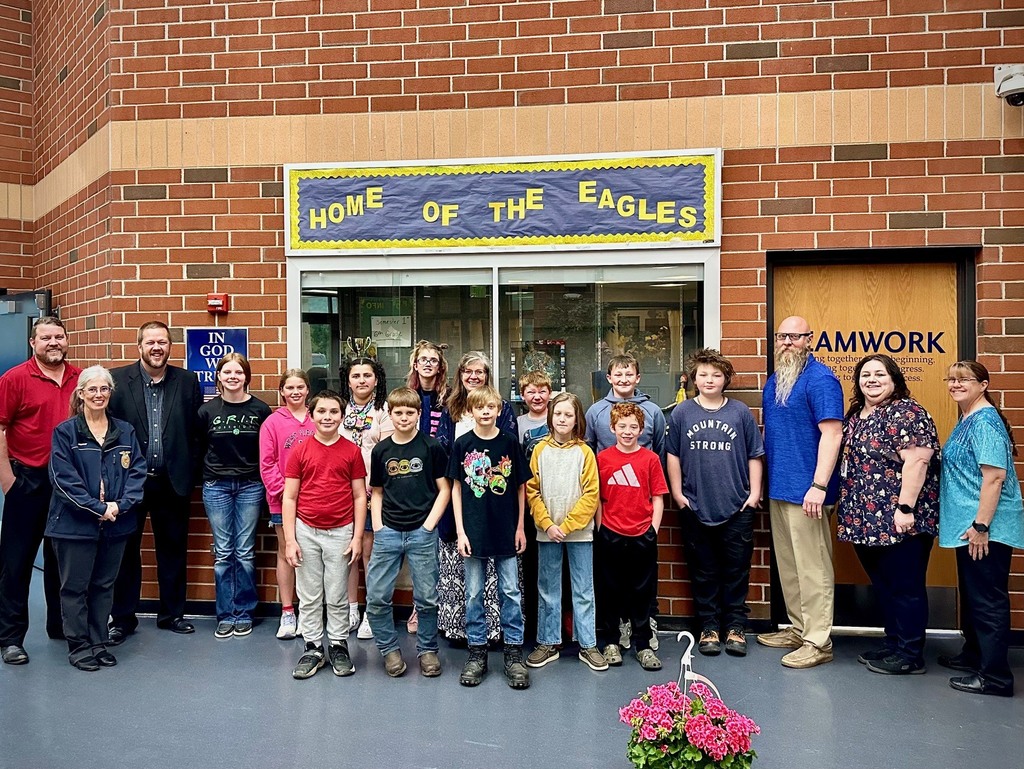 students pose with board members to be recognized for achievement