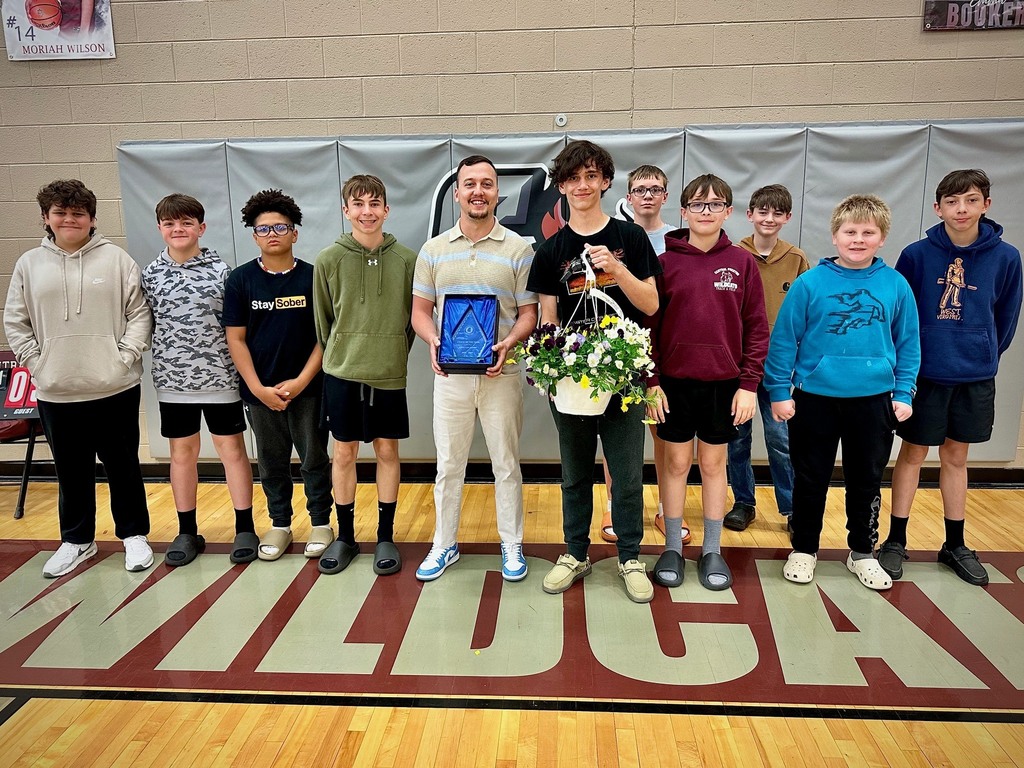 students pose with board members to be recognized for achievement