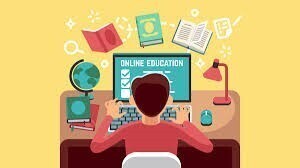 Student in a read shirt on a computer surrounding by textbooks of all subjects