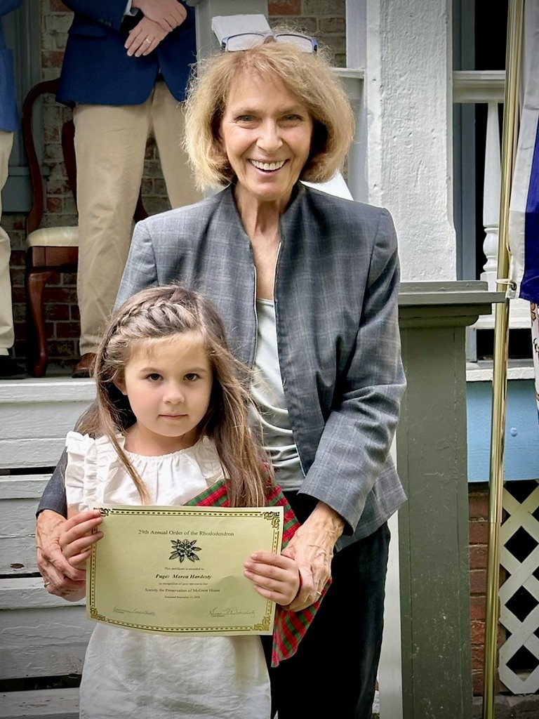 students pose with adults after receiving an award