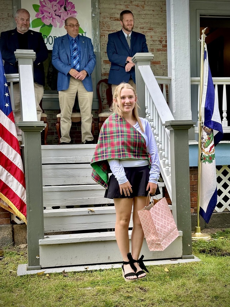 students pose with adults after receiving an award