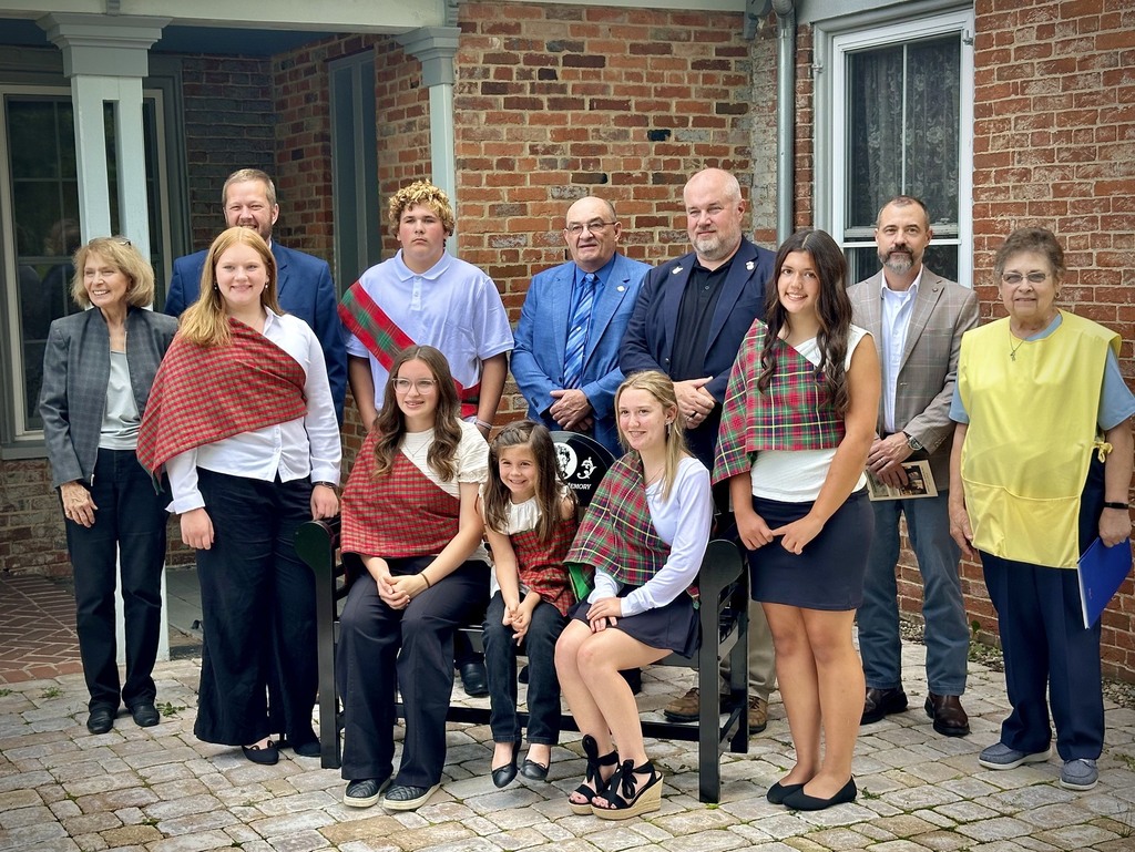 students pose with adults after receiving an award