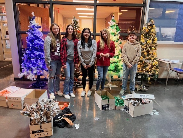 CPMS members of NJHS decorate Christmas trees in the colors of the four houses of CPMS (similar to Harry Potter houses).