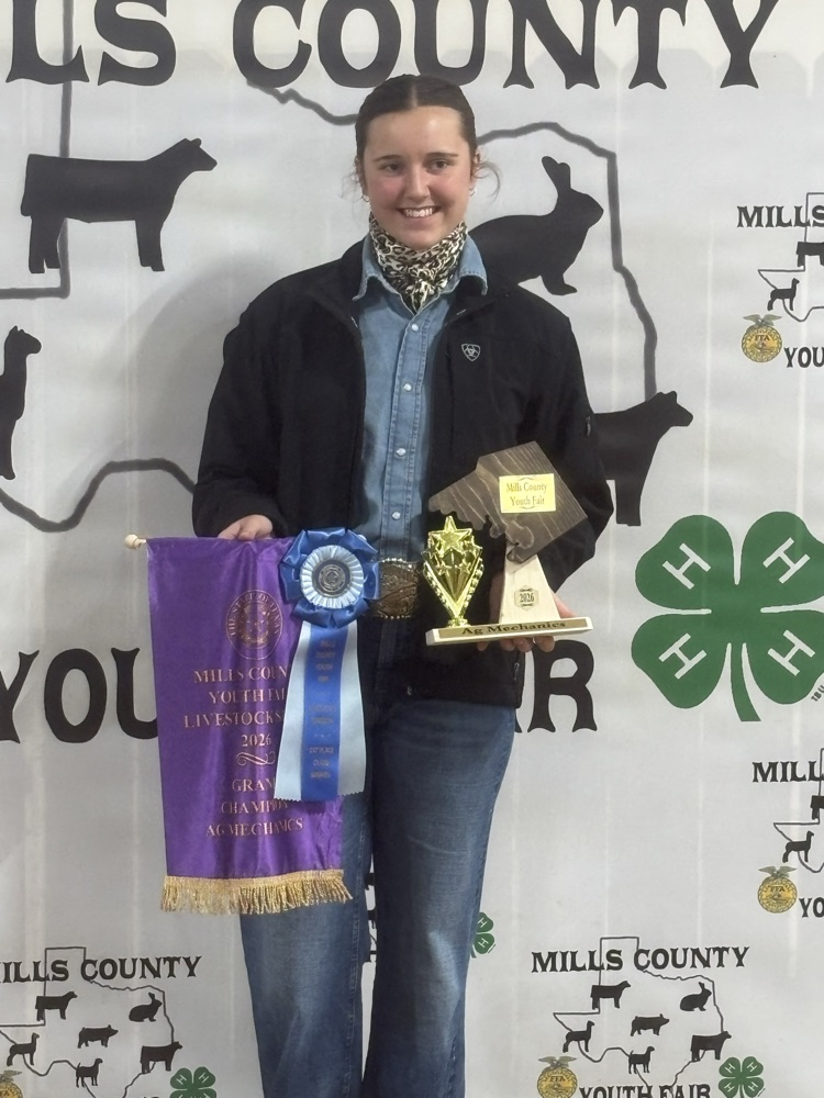 Sadie standing at the backdrop 
