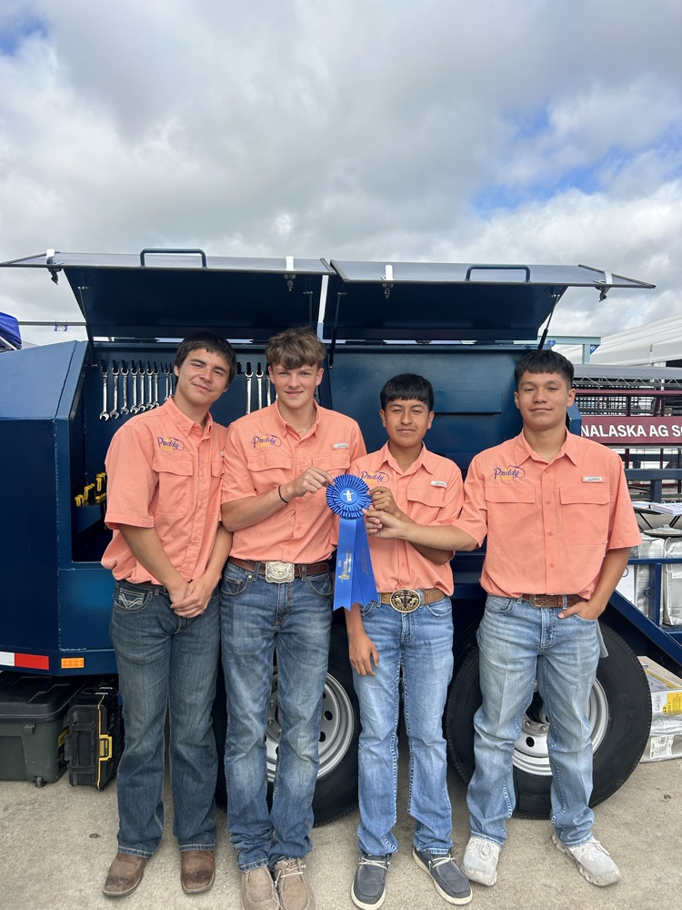 Jaxon, Brailen, Diego, and Luis with their fuel trailer