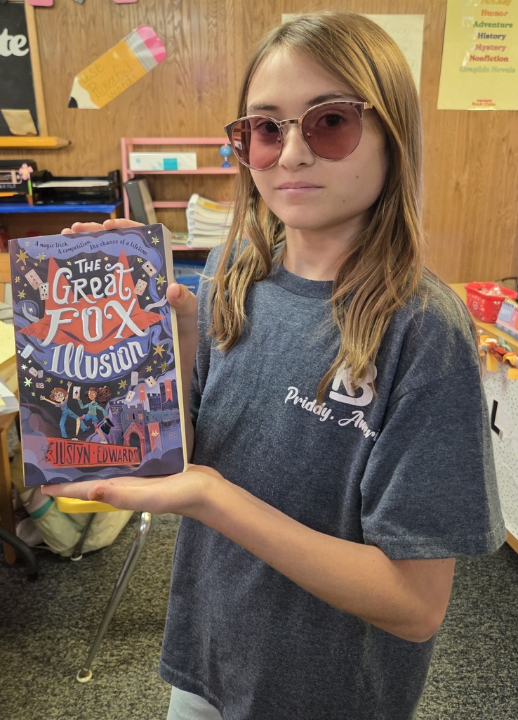 7th grader, Skylar, shows her prize. She's almost done reading her new book. So far, she loves the story!