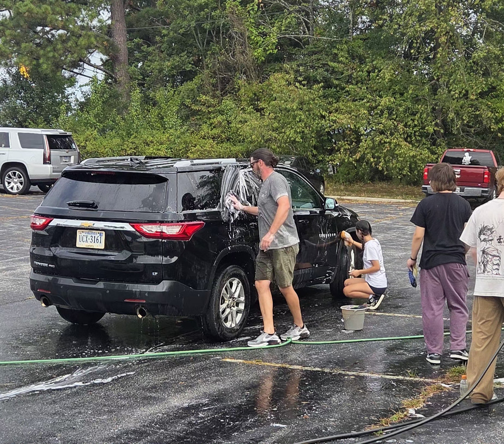 people washing black car