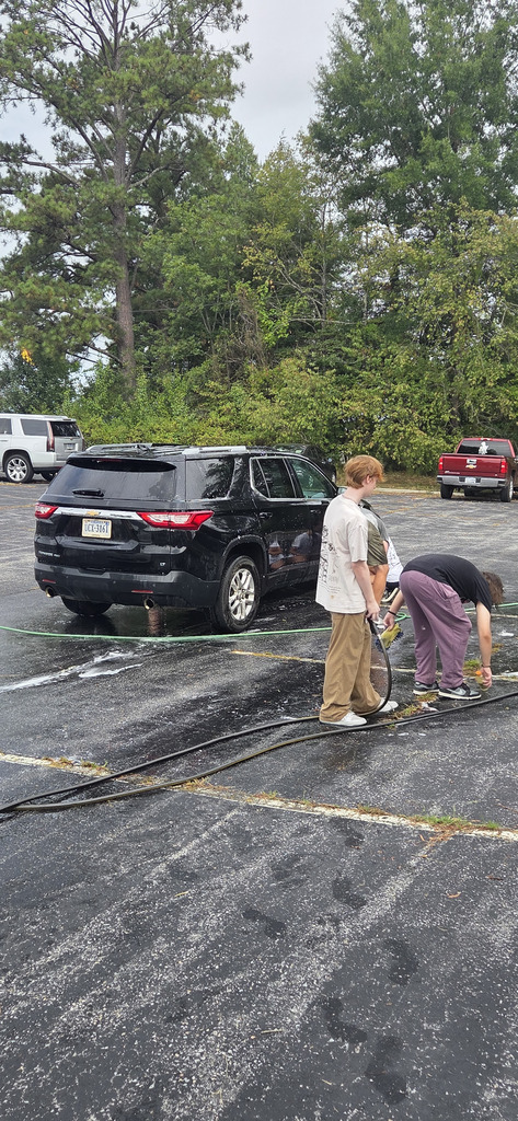 students washing car