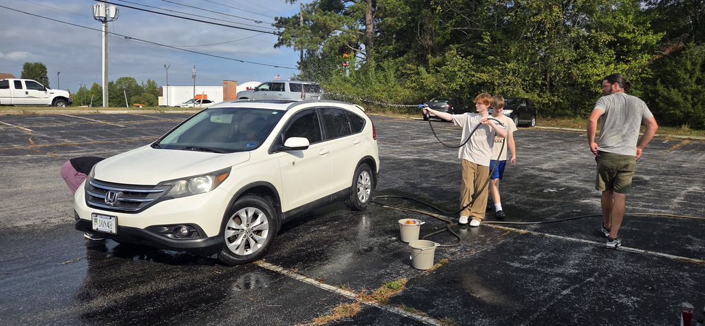 students washing car