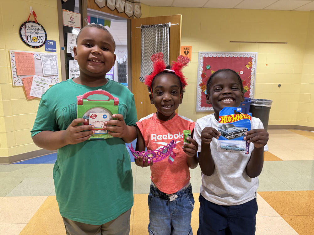 Students at Lincoln Heights showing off what they "bought" at the Viking Store