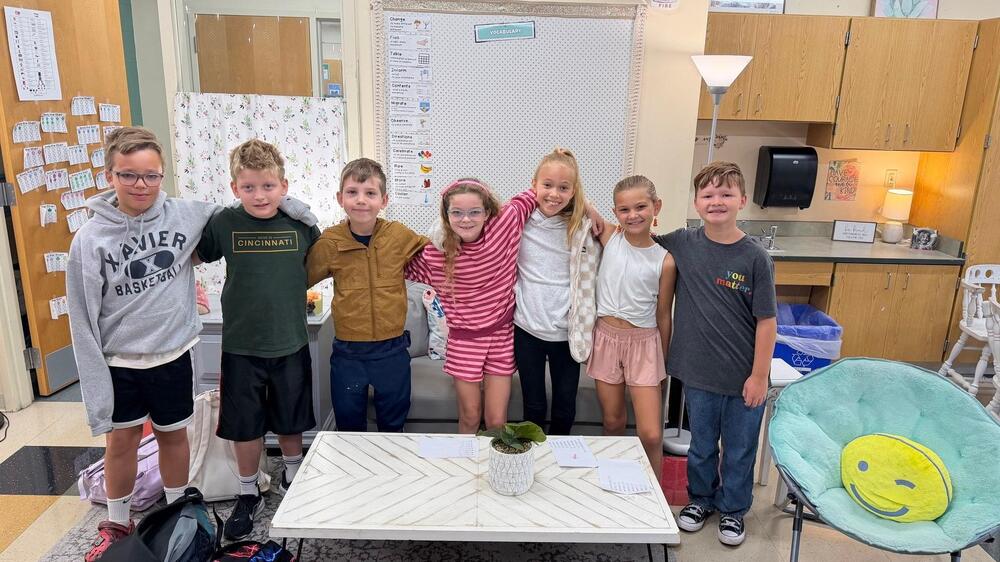 students standing in front of a board