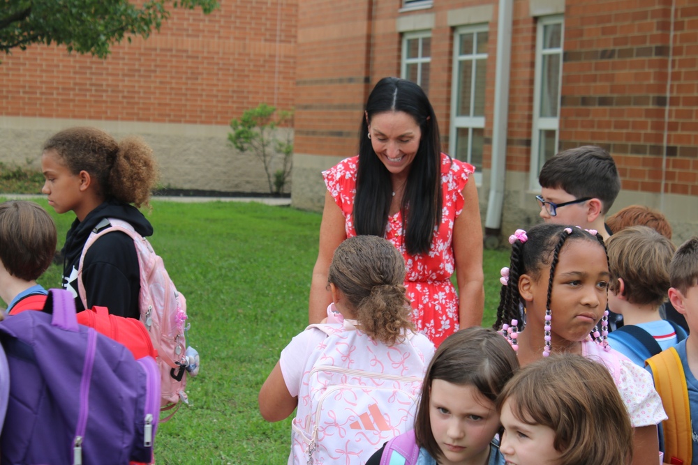 Evendale teacher talking to students during bus line-up at the end of the First Day of School