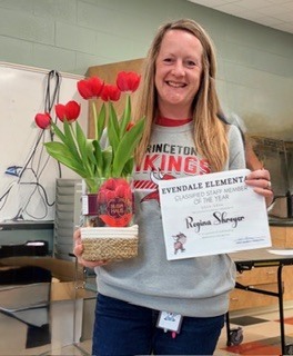 picture of woman with flowers and certificate