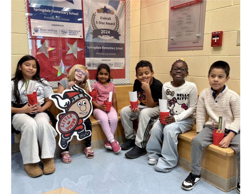 Springdale Elementary students pose together holding Viking tickets after being recognized as winners for making good choices during the week.