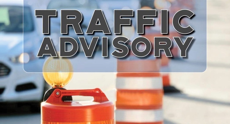 traffic advisory with an orange safety barrel and City of Springdale logo