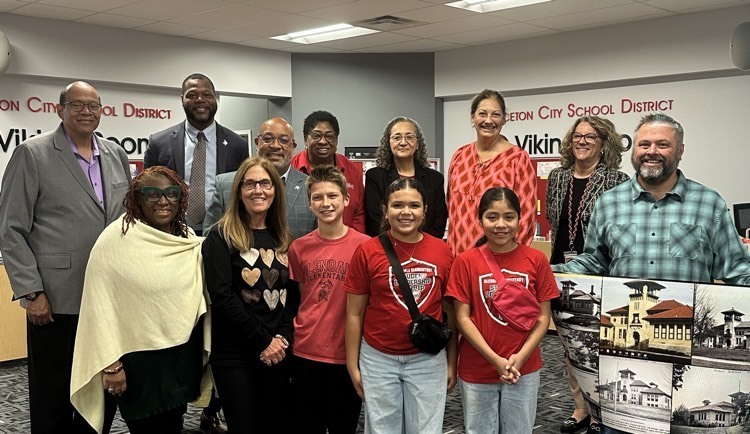 Glendale students with Princeton Board of Education members. Mr. Blythe holds a poster of historical photos from Glendale through the years. 