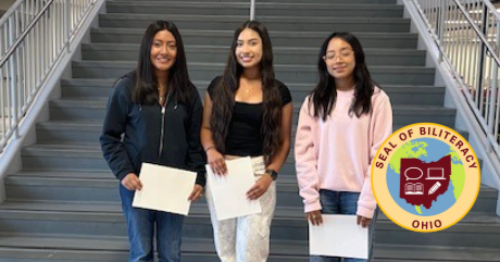 Jennifer Mendoza Lopez, Annette Flores, Antonia Martinez, along with Jakilin Carranza (not pictured) and 2025 graduate Eli Alanis (also not pictured; currently pursuing college studies), have demonstrated outstanding proficiency in both English and at least one additional world language through rigorous language acquisition assessments.  The three girls are standing by the Viking stairwell and there is a seal of biliteracy image on the lower right corner.