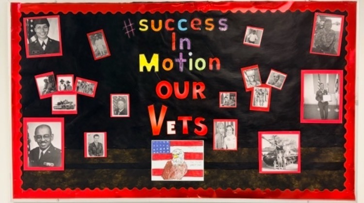 Innovation Center bulletin board. Black background with red trim, featuring photographs of staff and employees who are veterans. 